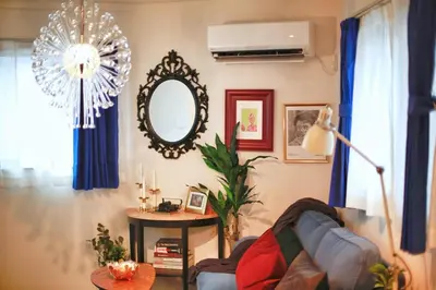 a living room with a couch and a mirror at SG5371 Visit Shibuya Crossing! Walking distance to a single family home for 8 people, private parking , downstairs supermarket food Shibuya in Tokyo