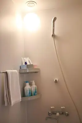 a bathroom with a shower and a toilet with towels at BRT101 Ikebukuro Station , Double Apartment , Yamanote Line direct access to Shinjuku Shibuya, convenient transportation, fully equipped in Tokyo