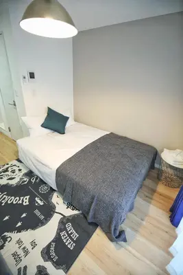 a bedroom with a bed with a blanket on it at BRT202 Ikebukuro Station , Apartment for 2 people, direct access to Shinjuku and Shibuya on the Yamanote Line, convenient transportation, well-equipped in Tokyo
