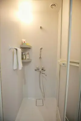 a white bathroom with a shower and a toilet at BRT203 Ikebukuro Station Double Apartment in a Busy Business District, Yamanote Line and 8 Subway Lines Direct to Shinjuku, Shibuya, Ginza, Akihabara, Fully Equipped in Tokyo