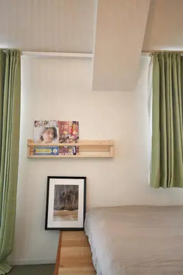 a bedroom with a bed and green curtains at BRT301 Ikebukuro Station Double Apartment in a Busy Business District, Yamanote Line and 8 Subway Lines Direct to Shinjuku, Shibuya, Ginza, Akihabara, Fully Equipped in Tokyo