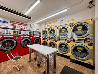 a row of washing machines in a laundry room at torico takinogawa in Tokyo