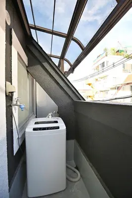 a washing machine in a balcony with a window at BRT302 Ikebukuro Station Double Apartment , Yamanote Line direct access to Shinjuku Shibuya, convenient transportation, fully furnished in Tokyo