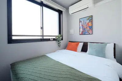 a bedroom with a bed and a window at Monzen-Nakacho Stylish 1LDK with 2 Double Beds in Tokyo