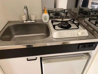 a kitchen with a sink and a stove at 102 Nishi-Shinjuku 5-chome MRT station 5 minutes on foot in Tokyo