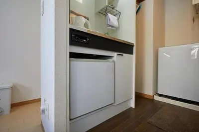 a kitchen with a white stove and a refrigerator at 102 Nishi-Shinjuku 5-chome MRT station 5 minutes on foot in Tokyo
