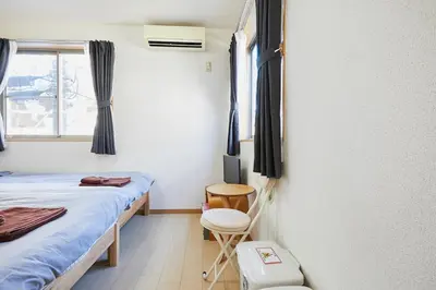 a small room with two beds and a window at 102 Nishi-Shinjuku 5-chome MRT station 5 minutes on foot in Tokyo