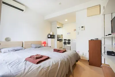 a bedroom with a bed with two towels on it at 201 Nishi-Shinjuku-Gochome Station 5 minutes on foot in Tokyo