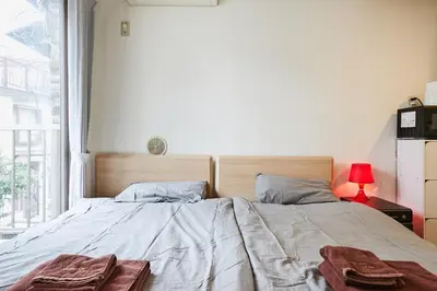 a bedroom with a bed with two towels on it at 201 Nishi-Shinjuku-Gochome Station 5 minutes on foot in Tokyo