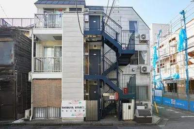 a spiral staircase on the side of a building at 201 Nishi-Shinjuku-Gochome Station 5 minutes on foot in Tokyo