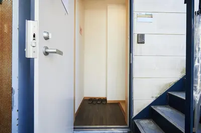 a pair of shoes sitting on the floor next to a door at 202 Nishi-Shinjuku Gochome Station 5 minutes on foot in Tokyo