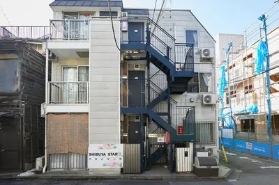 a building with a spiral staircase on the side of it at 301 Nishi-Shinjuku-Gochome Station 5 minutes on foot in Tokyo