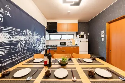 a dining room with a table and a kitchen at Senjushuku FUJI 201 \u5317\u5343\u4f4f in Tokyo