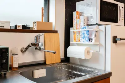 a kitchen counter with a sink and a microwave at Senjushuku FUJI 201 \u5317\u5343\u4f4f in Tokyo