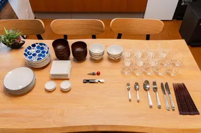 a table with plates and glasses and utensils on it at Senjushuku FUJI 201 \u5317\u5343\u4f4f in Tokyo