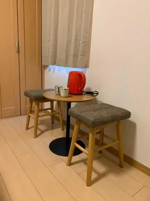 a table and two chairs with a red bag on it at 302 Nishi-Shinjuku-Gochome Station 5 minutes on foot in Tokyo