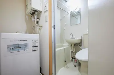 a bathroom with a shower and a toilet and a sink at 302 Nishi-Shinjuku-Gochome Station 5 minutes on foot in Tokyo