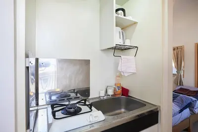 a kitchen with a sink and a stove at 302 Nishi-Shinjuku-Gochome Station 5 minutes on foot in Tokyo