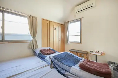 a bedroom with two beds and a window at 302 Nishi-Shinjuku-Gochome Station 5 minutes on foot in Tokyo