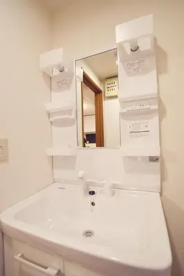 a bathroom with a white sink and a mirror at 103 3-minute walk to Nishi-Shinjuku 5-chome Station in Tokyo