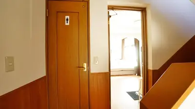 a wooden door in a room with a window at 103 3-minute walk to Nishi-Shinjuku 5-chome Station in Tokyo
