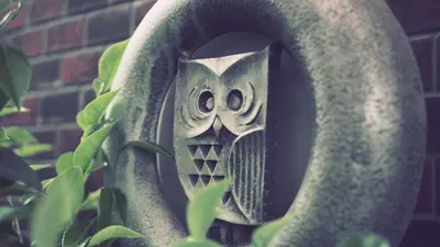 a statue of an owl in a plant at 103 3-minute walk to Nishi-Shinjuku 5-chome Station in Tokyo