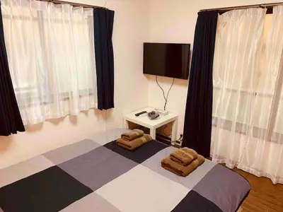 a bedroom with a bed with two towels on it at Shibuya Star 101 4 mins to Shinjuku Free WiFi in Tokyo