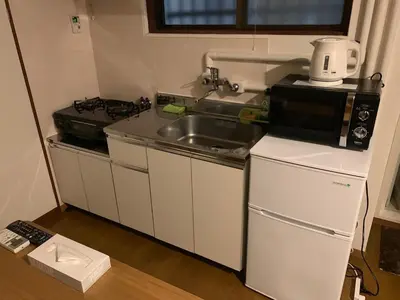 a small kitchen with a sink and a microwave at Shibuya Star 102-4 mins to Shinjuku-Free WiFi in Tokyo