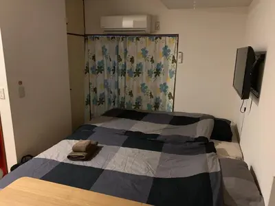a bedroom with a bed with a quilt on it at Shibuya Star 102-4 mins to Shinjuku-Free WiFi in Tokyo