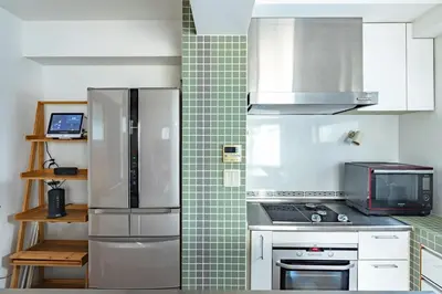 a kitchen with a refrigerator and a microwave at JR LINE Neko and Mado in Tokyo