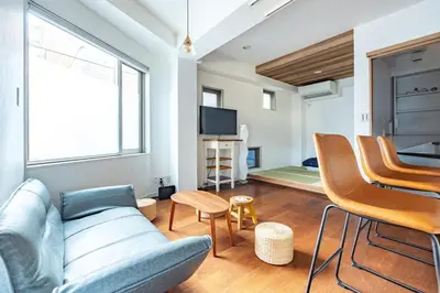a living room with a couch and chairs at JR LINE Neko and Mado in Tokyo