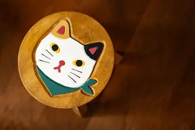 a cat cut out on a wooden coaster at JR LINE Neko and Mado in Tokyo