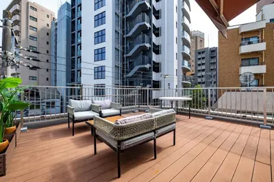 a balcony with two chairs and a table on a building at JR LINE Neko and Mado in Tokyo