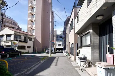 a city street with buildings and a car parked on the street at Ueno Hoshi-5 minutes from Iriya Station-1 stop from Ueno station in Tokyo