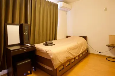 a bedroom with a bed with a teddy bear on it at Ueno Hoshi-5 minutes from Iriya Station-1 stop from Ueno station in Tokyo