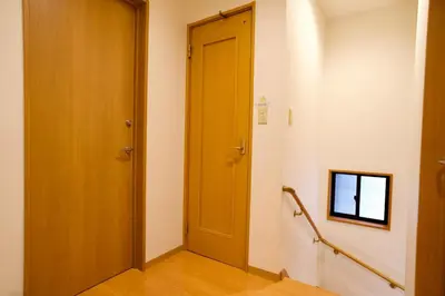 a hallway with a wooden door in a room at Ueno Hoshi-5 minutes from Iriya Station-1 stop from Ueno station in Tokyo