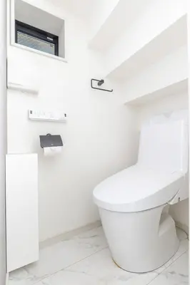 a white bathroom with a toilet and a window at JR Line yamanote ikebukuro in Tokyo
