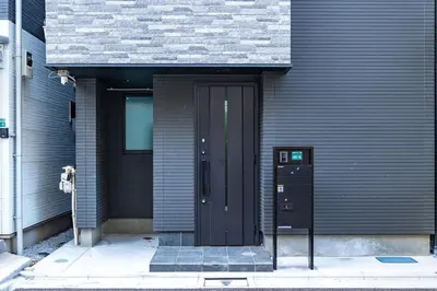 a black door on the side of a building at JR Line yamanote ikebukuro in Tokyo
