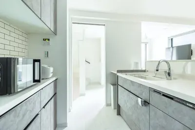 a kitchen with a sink and a microwave at JR Line yamanote ikebukuro in Tokyo
