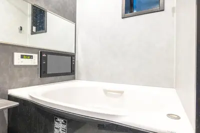 a bathroom with a white bath tub with a microwave at JR Line yamanote ikebukuro in Tokyo