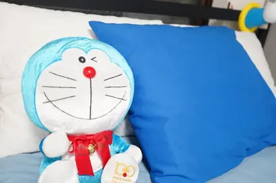 a stuffed cat toy sitting on top of a bed at 2 beds near Higashinakano st. 5 min to Shinjuku in Tokyo