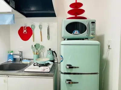 a microwave on top of a refrigerator in a kitchen at 2 beds near Higashinakano st. 5 min to Shinjuku in Tokyo