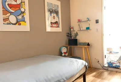 a bedroom with a bed and paintings on the wall at 2 beds near Higashinakano st. 5 min to Shinjuku in Tokyo