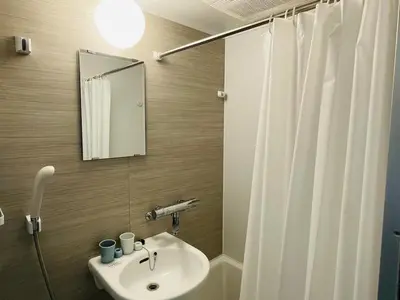 a bathroom with a sink and a mirror at 2 beds near Higashinakano st. 5 min to Shinjuku in Tokyo