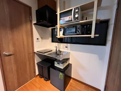 a small kitchen with a sink and a microwave at \u306b\u3058\u3044\u308d\u90b8\u6771\u4eac\u5927\u5cf6\u99c5\u524d in Tokyo
