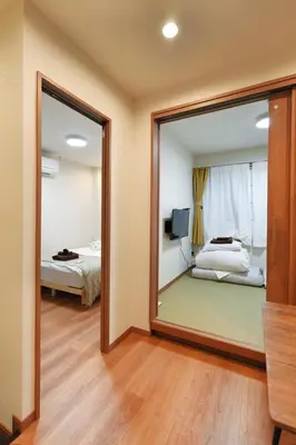 a mirror in a room with a bed and a bedroom at BSY202 Ueno Kozuki 202, 3 mins walk to subway station, rare listing, Ueno walking business district, cost-effective in Tokyo