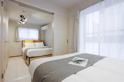 a hotel room with two beds and a window at \u30f4\u30a3\u30f3\u30c6\u30fc\u30b8CiTY\u62bc\u4e0a in Tokyo