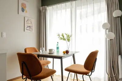 a dining room with a table and chairs and a window at \u30f4\u30a3\u30f3\u30c6\u30fc\u30b8CiTY\u62bc\u4e0a in Tokyo