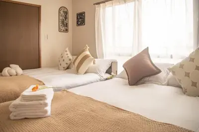 a bedroom with two beds with towels on them at \u4e1c\u4eac\u90fd\u4e2d\u91ce\u533a in Tokyo
