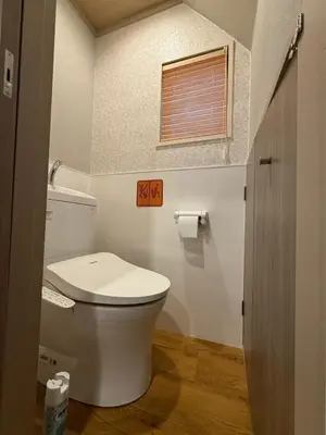 a bathroom with a white toilet and a window at Pagi Hotel in Tokyo